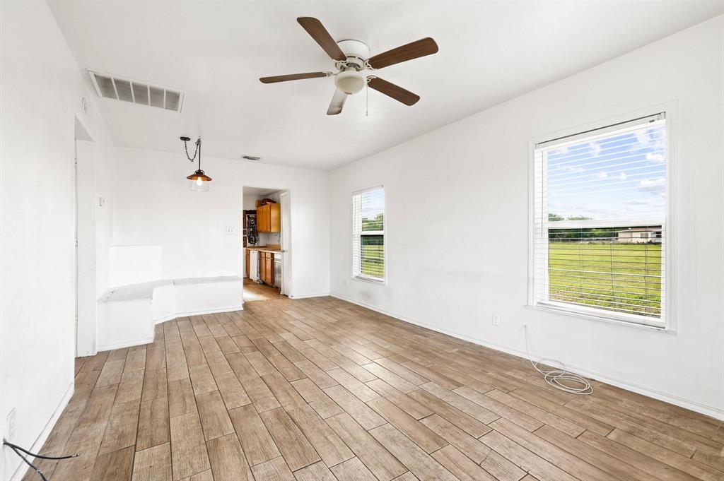 2092 County Road 5010 Blue Ridge, TX 75424 - Photo 10 of 28 a view of an empty room with wooden floor and a window