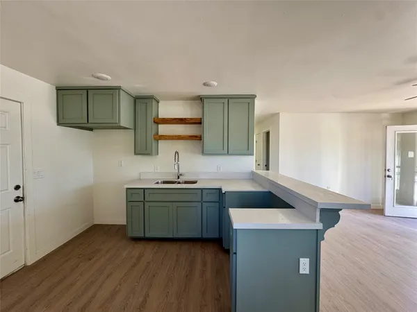 a kitchen with stainless steel appliances granite countertop a sink and a stove top oven