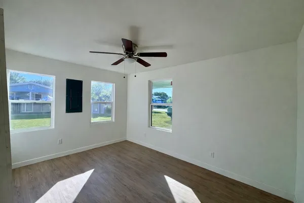 wooden floor in an empty room with a window