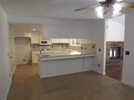 a kitchen with stainless steel appliances a refrigerator sink and cabinets
