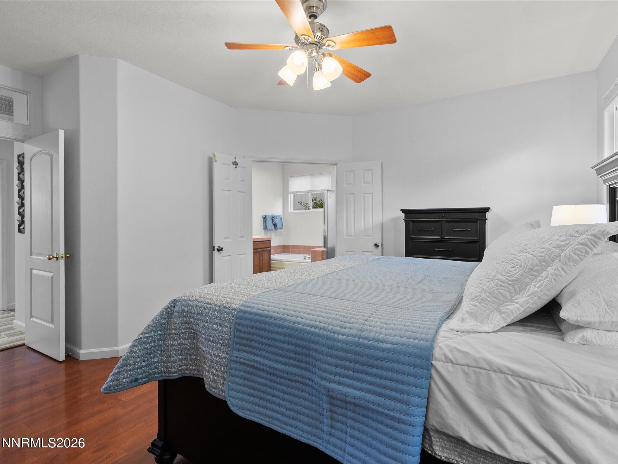 3101 Green River Drive Reno, NV 89503 - Photo 26 of 62 a bedroom with a bed and a chandelier