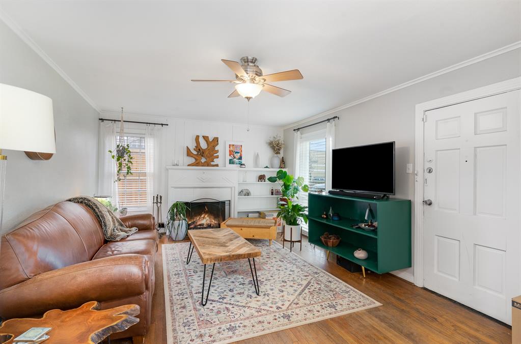 a living room with furniture a fireplace and a flat screen tv