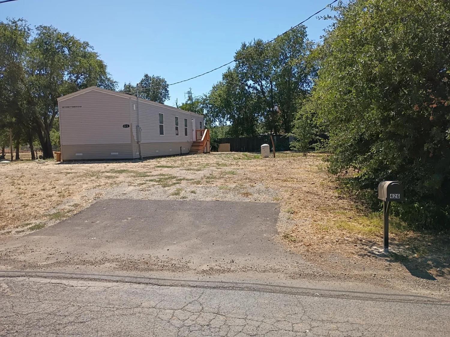 426 Stimpson Road Oroville, CA 95965 - Photo 2 of 16 a wooden bench sitting in middle of a field