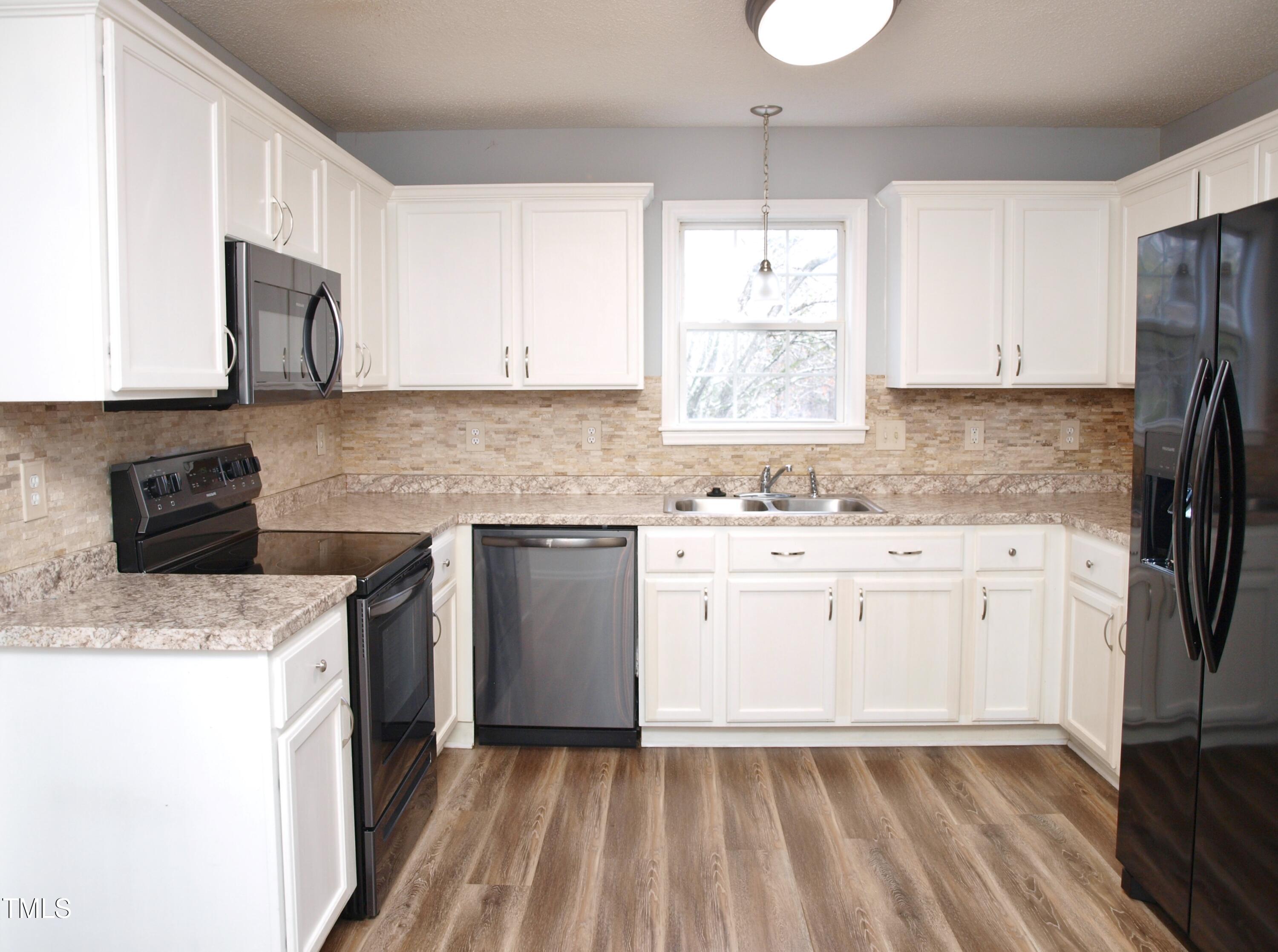 2000 Ruddy Road Raleigh, NC 27616 - Photo 8 of 20 a kitchen with a sink stove and refrigerator