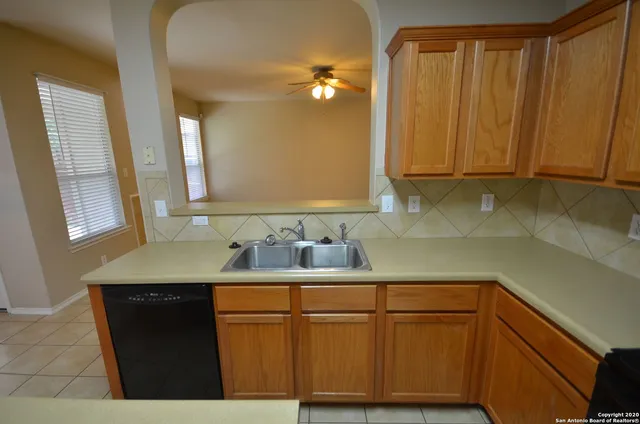 a kitchen with a sink a cabinets and window
