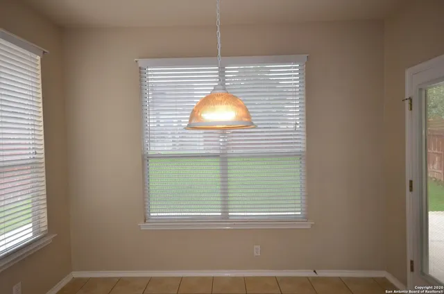 a room that has a window and a table in it