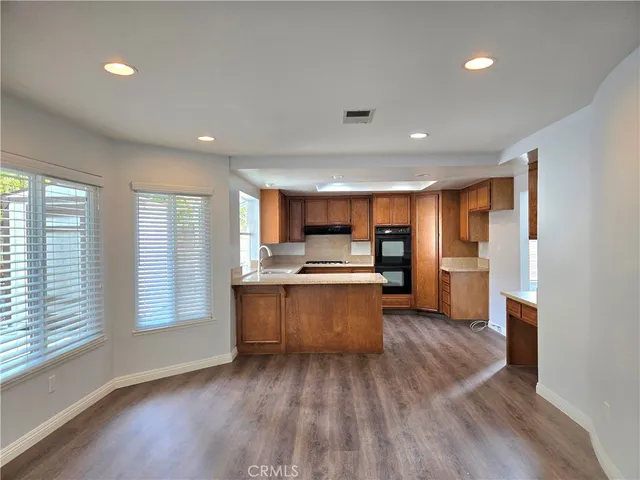 a view of kitchen with sink and wooden floor
