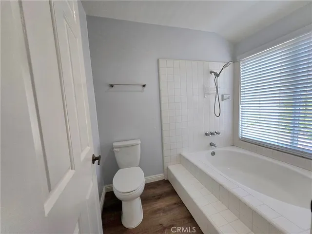 a bathroom with a toilet and a bathtub