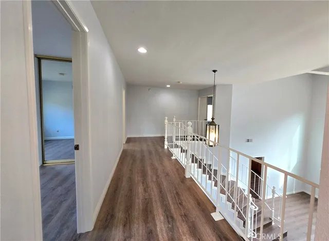 a view of entryway and hall with wooden floor