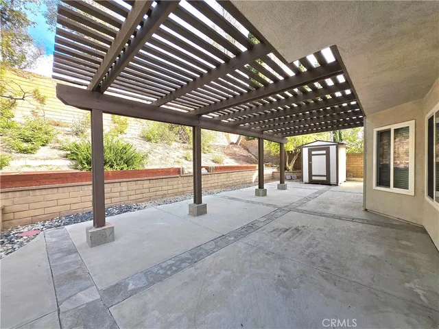 a view of porch with a table and chairs next to a yard