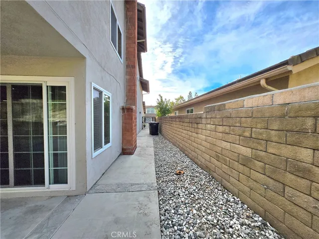 a view of a blue house with wooden fence