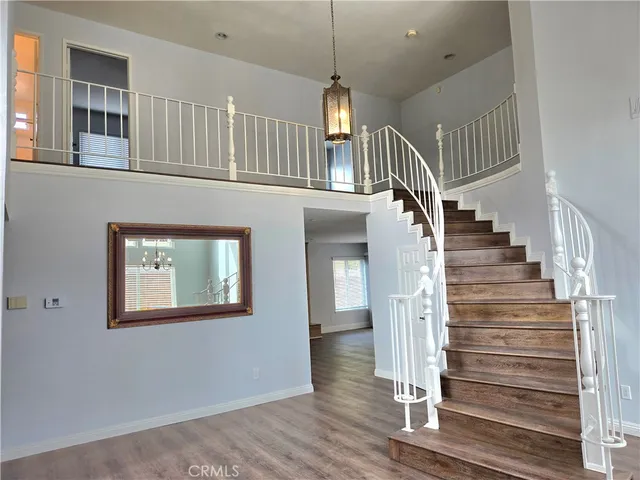 a view of entryway and hall with wooden floor