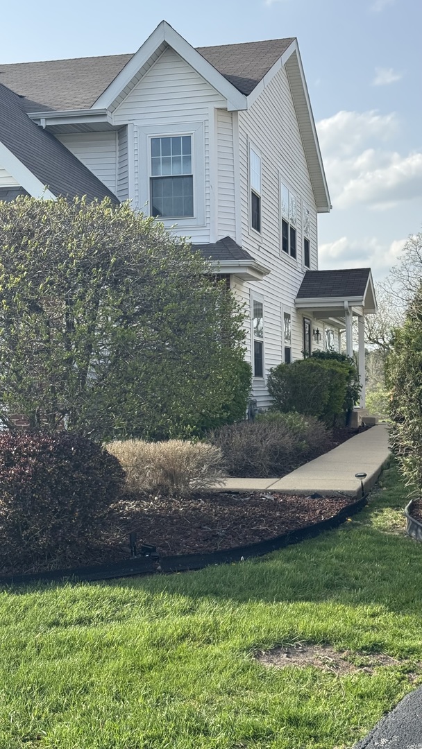 a front view of a house with a garden