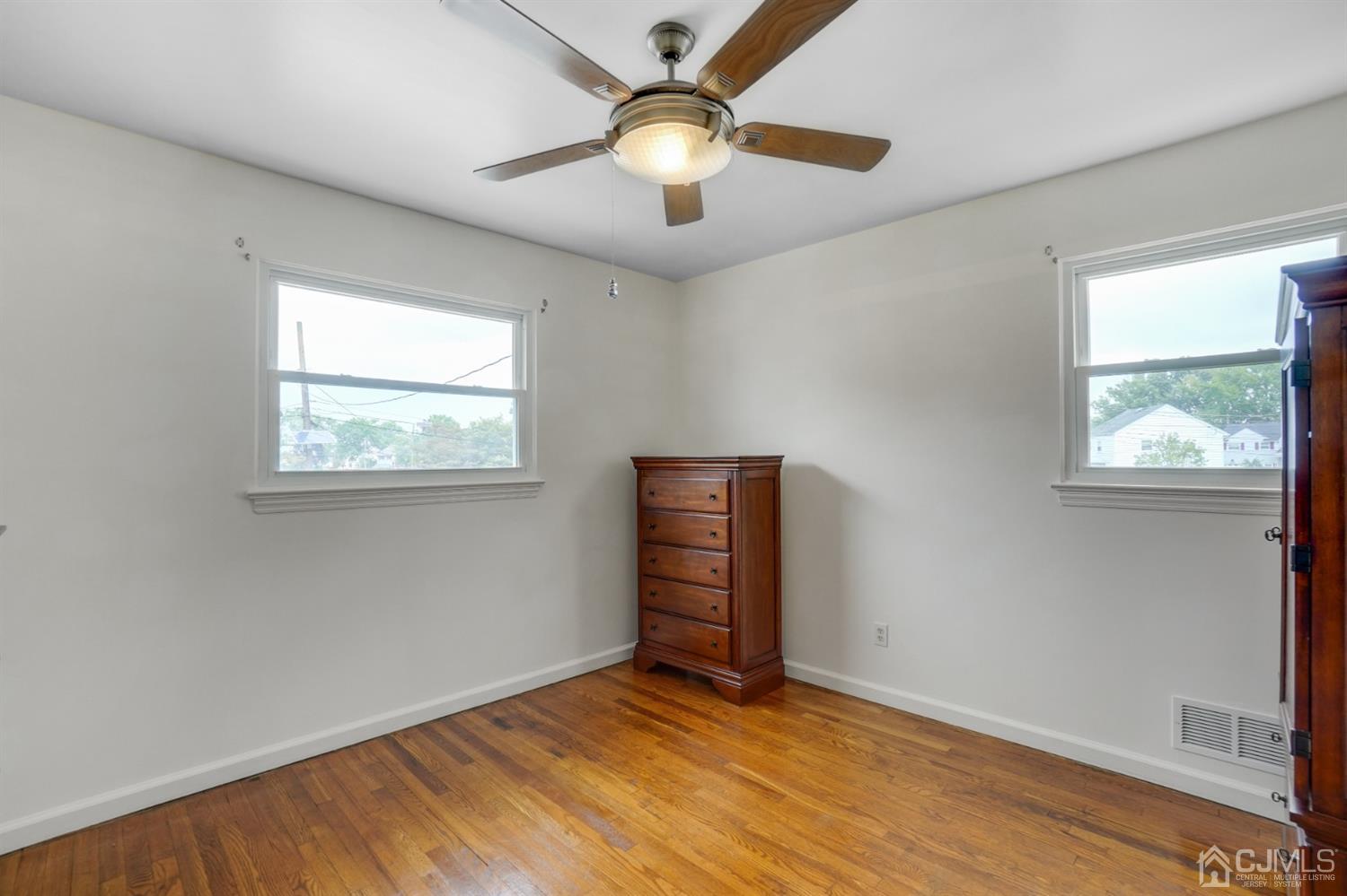 12 Leland Road Edison, NJ 08817 - Photo 17 of 23 a view of empty room with wooden floor and fan