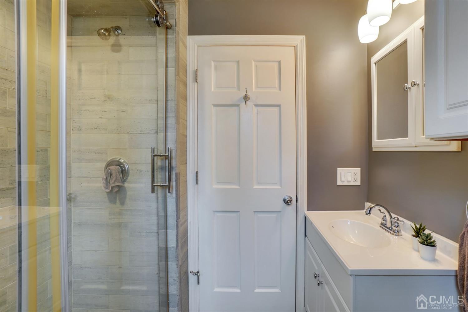 12 Leland Road Edison, NJ 08817 - Photo 19 of 23 a bathroom with a sink a shower and a mirror