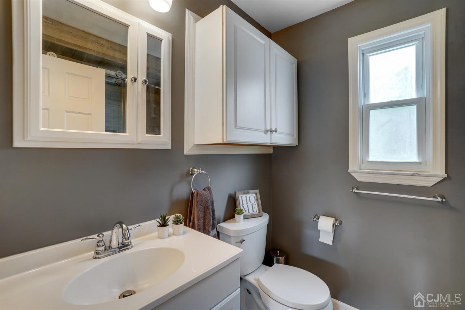 12 Leland Road Edison, NJ 08817 - Photo 20 of 23 a bathroom with a sink a toilet and a window