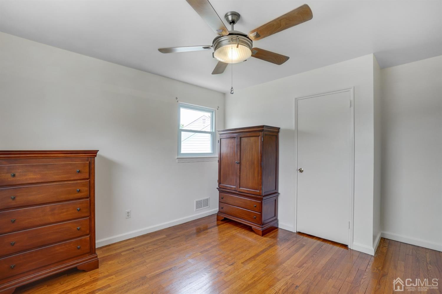12 Leland Road Edison, NJ 08817 - Photo 23 of 23 wooden floor in an empty room with a window