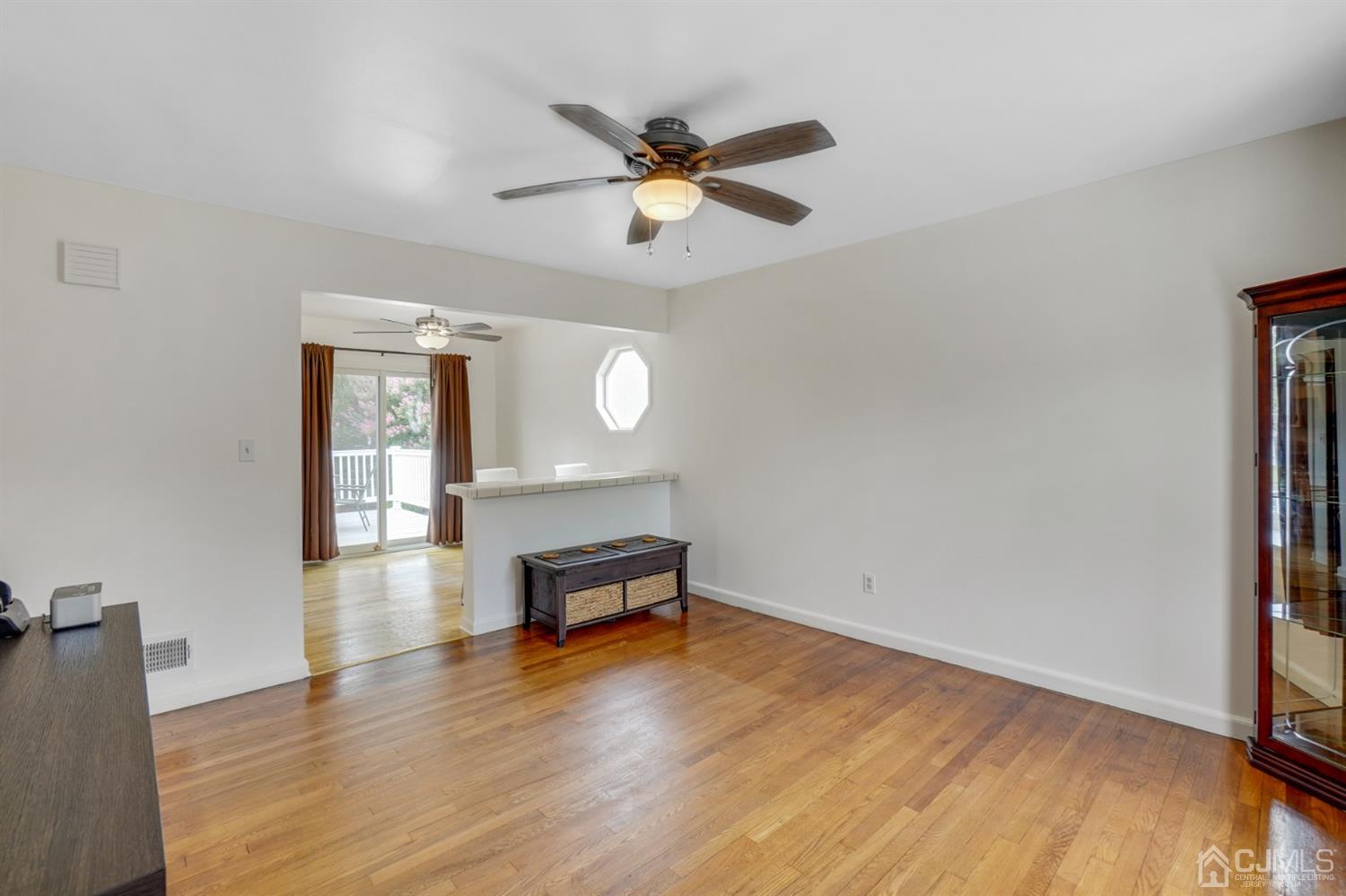 12 Leland Road Edison, NJ 08817 - Photo 9 of 23 a view of a livingroom with wooden floor and a ceiling fan
