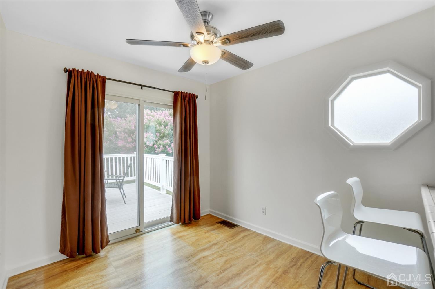 12 Leland Road Edison, NJ 08817 - Photo 10 of 23 a view of an empty room with a window and wooden floor