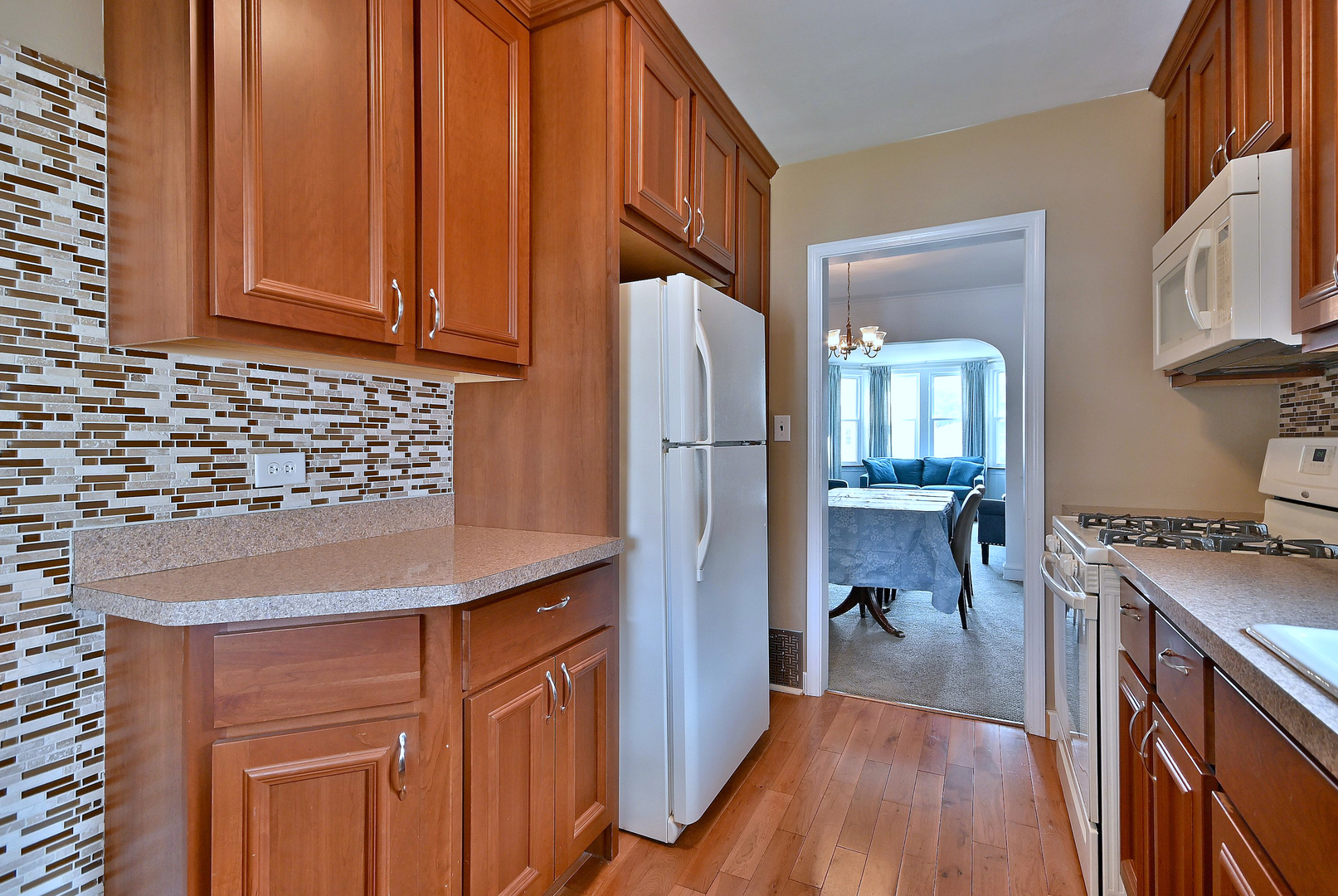 2852 North Meade Avenue Chicago, IL 60634 - Photo 11 of 31 a kitchen with stainless steel appliances granite countertop a refrigerator a stove and a wooden cabinets