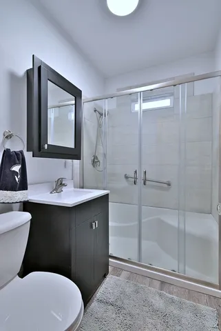 a bathroom with a sink toilet and shower