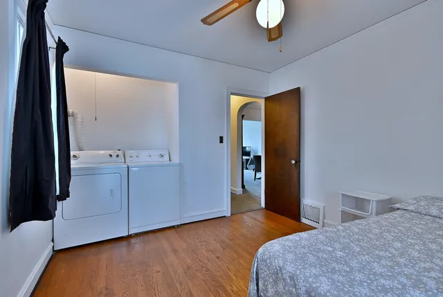 a bedroom with a bed and wooden floor