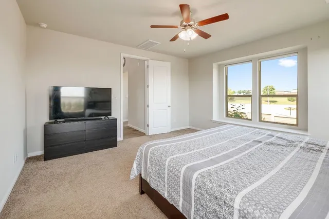 a bedroom with a bed and a flat screen tv