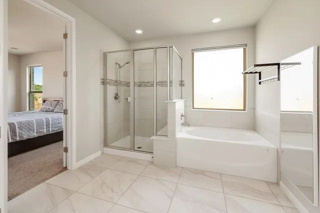 a bathroom with a tub shower and sink