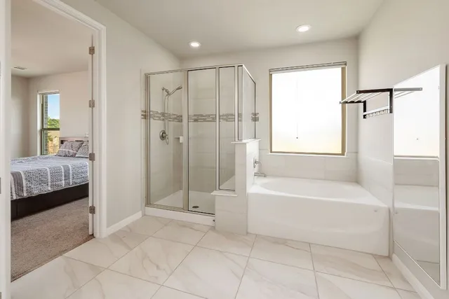 a bathroom with a tub shower and sink