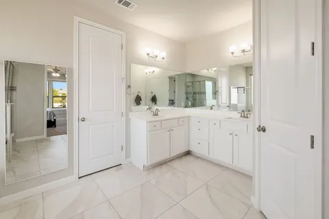 a view of a bathroom with sink and mirror