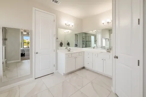 a view of a bathroom with sink and mirror