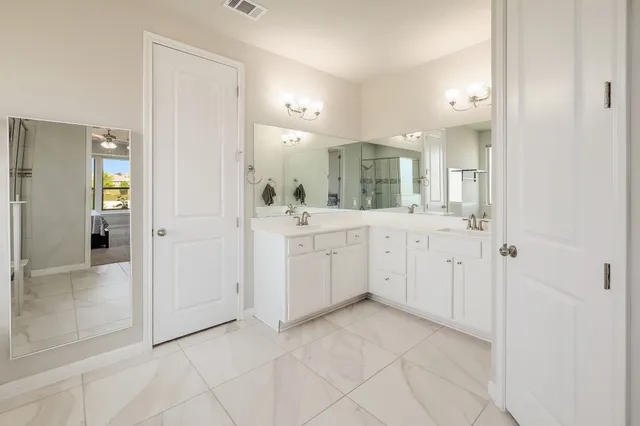a view of a bathroom with sink and mirror