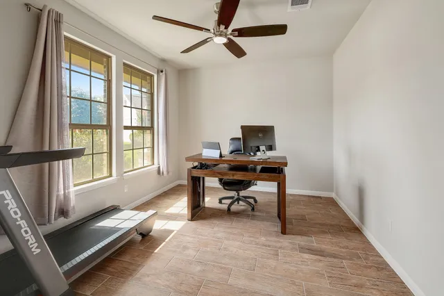 a workspace with wooden floor and a window