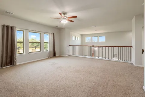 a view of a livingroom with a ceiling fan and window