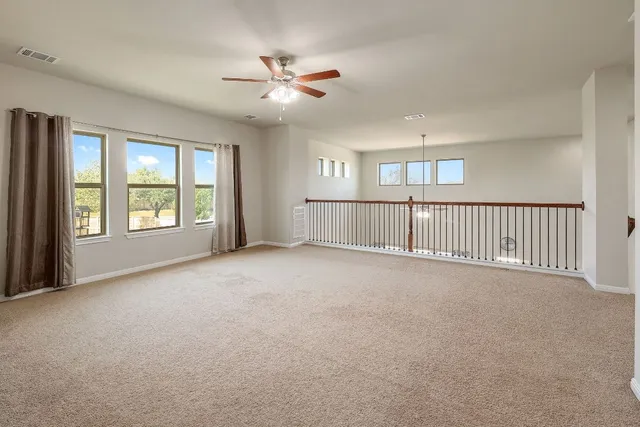 a view of a livingroom with a ceiling fan and window