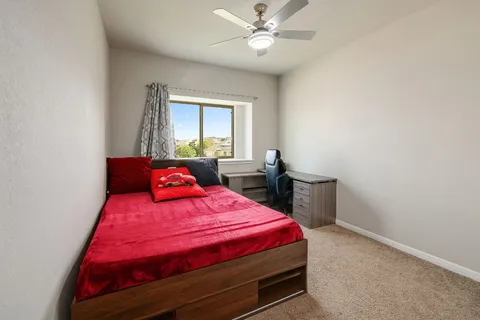 a bedroom with a bed and a chandelier