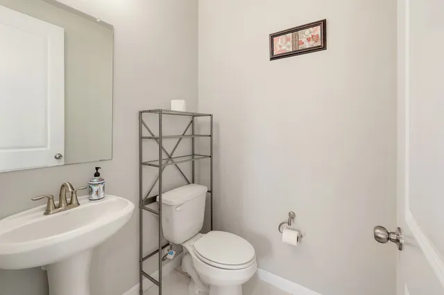 a white toilet sitting next to a bathroom sink