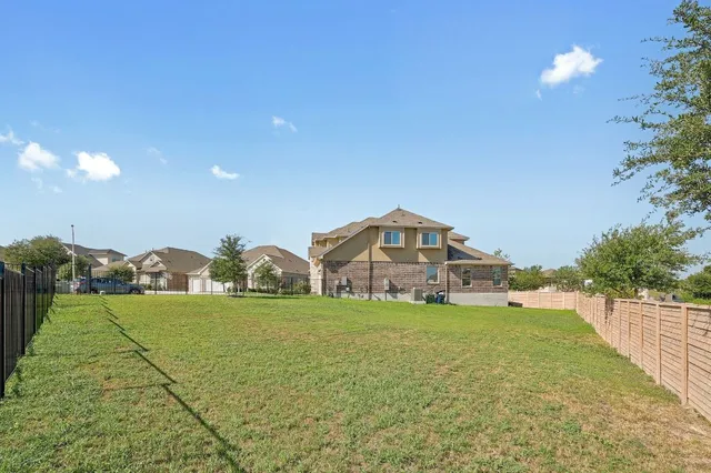 a view of a house with yard and porch