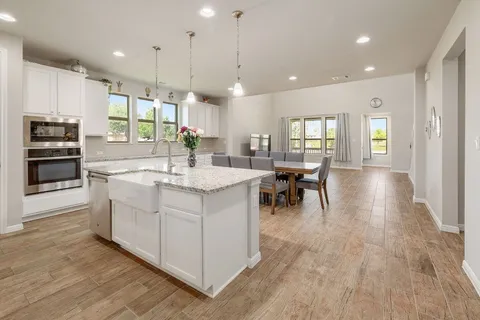 a large kitchen with kitchen island a sink a center island a stove and a center island