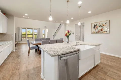 a view of a kitchen counter top space with furniture and wooden floor