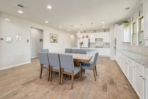 a view of a dining room with furniture and wooden floor