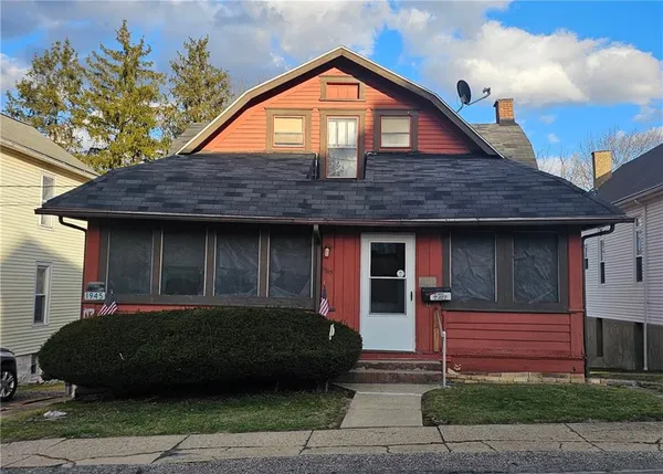 a view of a car parked front of a house