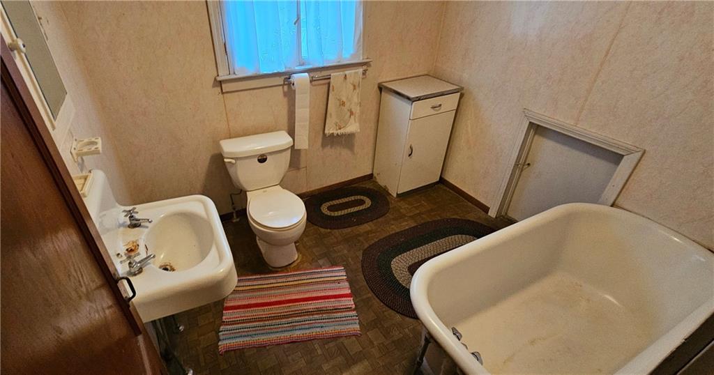 1945 Morris Street New Castle, PA 16102 - Photo 22 of 41 a bathroom with a toilet mirror and tub