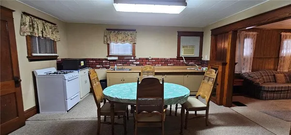 a kitchen with a dining table and chairs