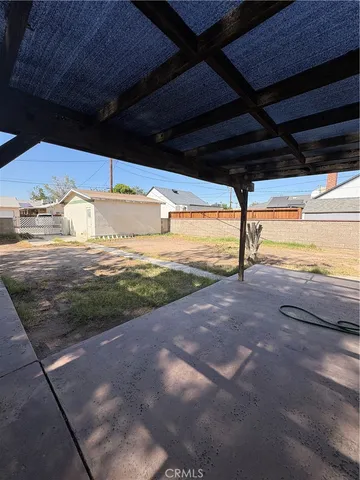 a view of a swimming pool with a table and chairs in patio