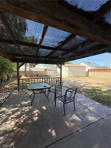 a view of a backyard with wooden fence