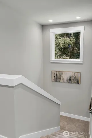 a view of a small space with wooden floor and a window