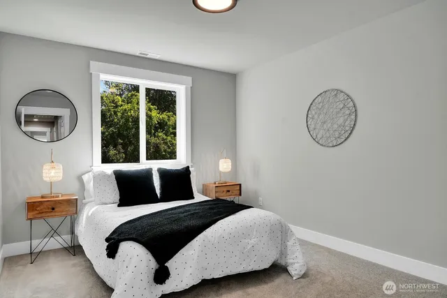 a bedroom with a bed lamp and a window