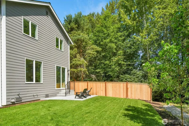 a view of a house with a yard and sitting area
