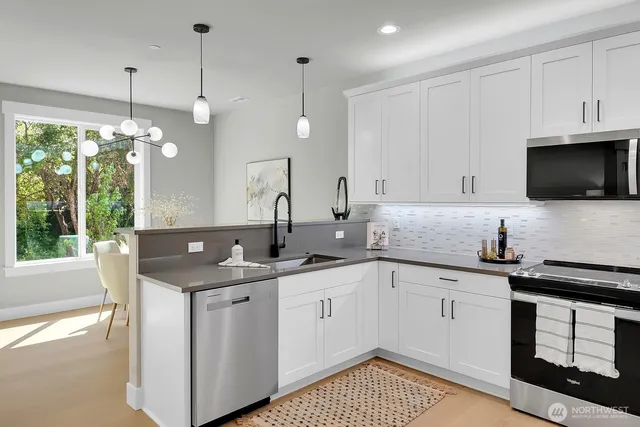 a kitchen with a sink stove and microwave